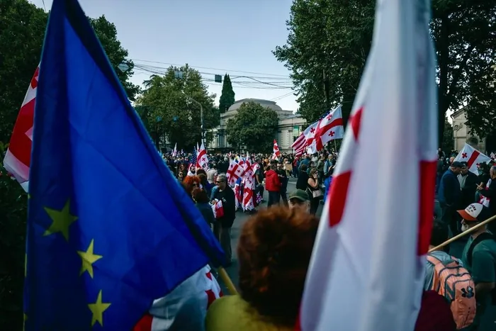 Protesters with Georgian and EU flags on a street in Tbilisi