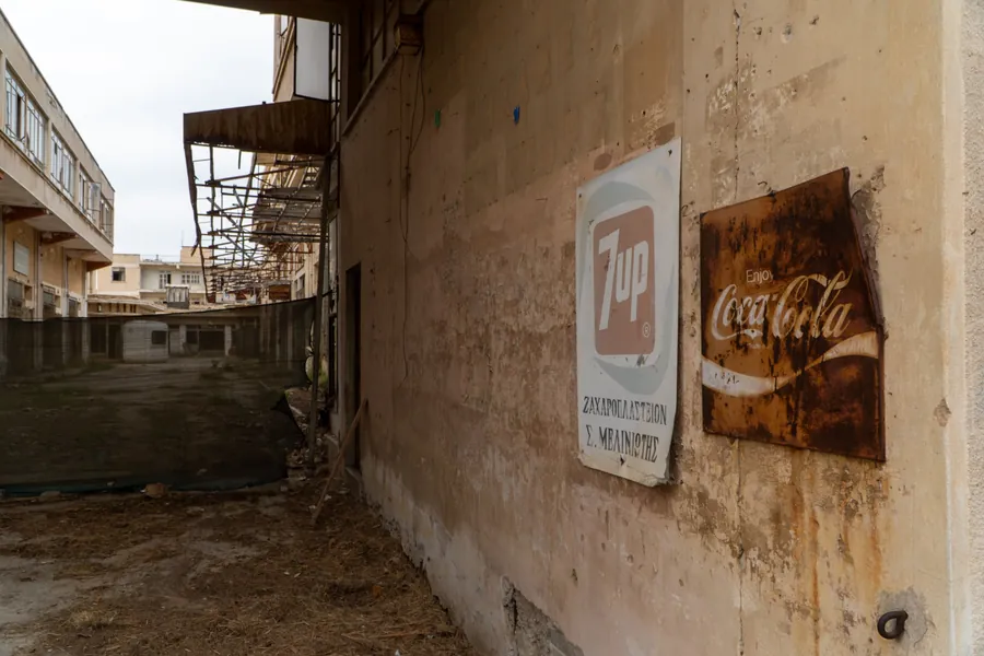 Old 7up and Coca-Cola signs on a crumbling wall